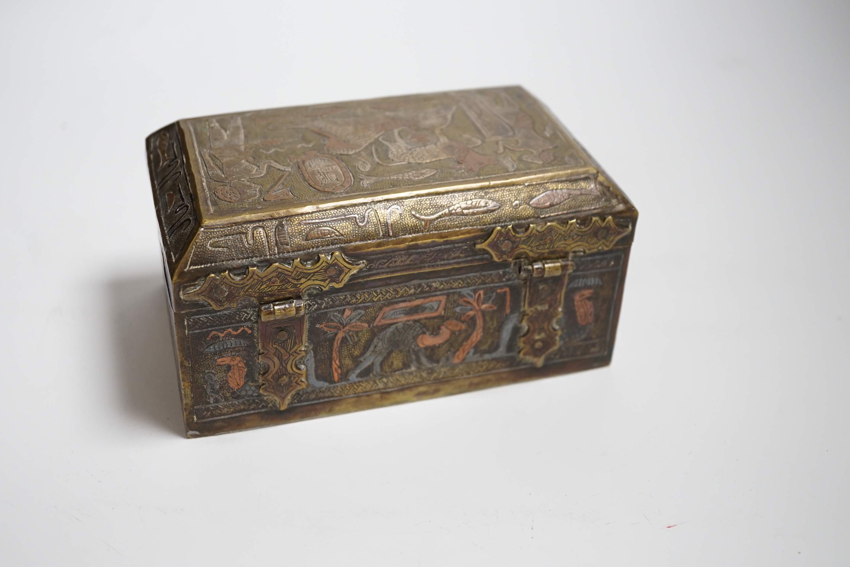 A Cairo ware box, decorated with ancient Egyptian figures, 15.5 cm wide